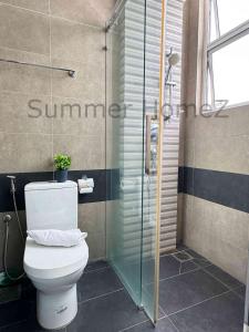 a bathroom with a toilet and a glass shower at 3BR 5-6Pax Zetapark Setapak Central Near Zoo in Kuala Lumpur