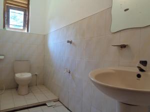 a bathroom with a sink and a toilet at Wellawaya Rest House in Wellawaya