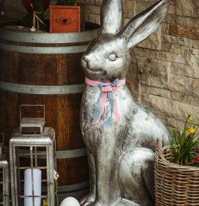 a statue of a rabbit sitting next to a cage at Apartmany pod Pustevnami in Prostřední Bečva