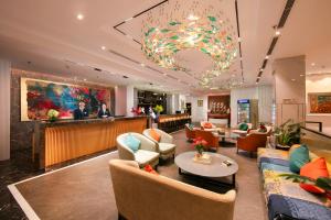 a lobby of a hotel with couches and a bar at GRAND CITITEL Hanoi Hotel & Spa in Hanoi