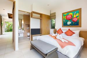 a bedroom with a large white bed and a bathroom at Resort Boutique 2BR Villa Dalaa 4, Private Pool, Full Service, 5 min Drive Kamala Beach in Kamala Beach