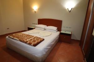 a bedroom with a bed with white sheets and pillows at Porto Sokhna Red Sea in Ain Sokhna