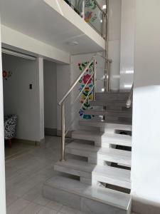 a staircase in a house with a mosaic stair case at PERLASCHALLAY in Ayacucho