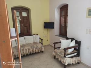 a living room with a couch and a chair at APARTMENTS by climbing house in Kalymnos