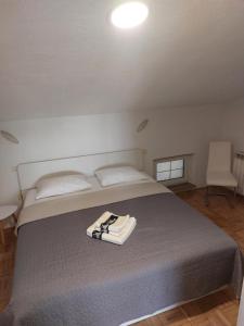 a bedroom with a bed with a pair of shoes on it at Apartma BALC in Koper