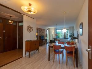 a dining room and living room with a table and chairs at Holiday Home in Veere near Historic Center in Veere