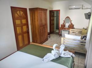 a bedroom with a bed with towels on it at Lucy's guesthouse in La Digue
