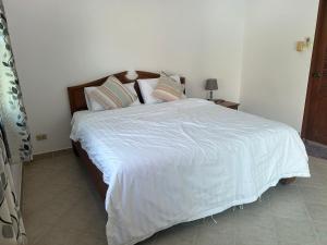a bedroom with a large bed with white sheets and pillows at Nirvana pool villa 2 in Nong Prue +21 photos