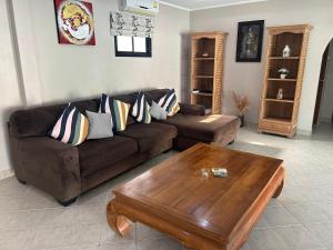 a living room with a couch and a coffee table at Nirvana pool villa 2 in Nong Prue