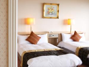 Postel nebo postele na pokoji v ubytování Grand Mercure Lake Hamana Resort & Spa