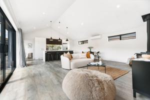 a living room with a couch and a table at Magic Central Wanaka Living in Wanaka +13 photos