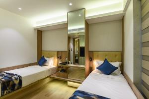 Postel nebo postele na pokoji v ubytování Hotel Eden Serenity