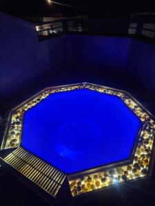 a blue swimming pool with lights around it at Walvis Bay Wind Beggars in Walvis Bay