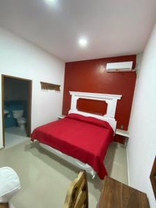 Un pat sau paturi într-o cameră la Hotel Doña Ana