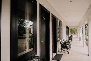 a row of chairs sitting on the side of a building at New Surya Hotel in Banyuwangi