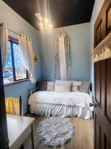 a bedroom with a bed and a chandelier at The Fairytale Cottage at High Rock Castle in Monroe