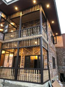 a building with a balcony on the side of it at Hideaway Cottages , Tangmarg in Tangmarg