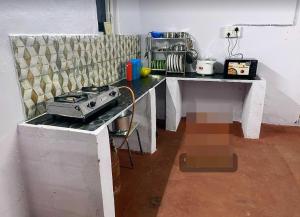 a kitchen with a counter with a stove on it at Seascape Villa in Hyderabad