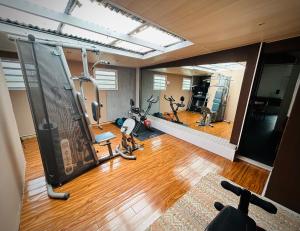 a gym with bikes and exercise equipment in a room at La Kaz du Volcan-Capacité maximum 10 personnes in La Plaine des Cafres