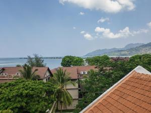 a view of houses and trees and the water at Langkawi Perdana Families Suite @ Langkawi Airport in Pantai Cenang