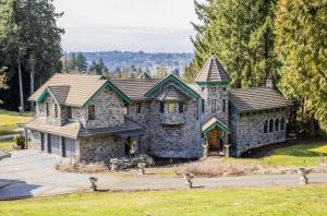 a large stone house with a roof at The Fairytale Cottage at High Rock Castle in Monroe