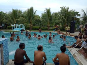 a group of people sitting in a swimming pool at RESORT k SEA VIEW in Digha
