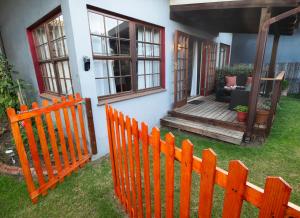 a wooden fence in front of a house at 139 Longships - Self Catering Flatlet in Plettenberg Bay