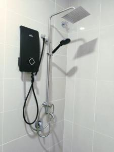 a shower with a shower head in a bathroom at Happy Chamang Guest House in Bentong +74 photos