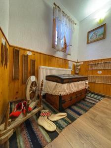 a bedroom with a bed and some shoes on the floor at Guest rooms Colorit in Koprivshtitsa