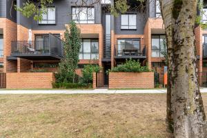 a brick building with a tree in front of it at Contemporary Tri-Level APT in a Prime Central Spot in Canberra