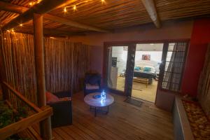 a living room with a table and a couch at 139 Longships - Cozy Double Room in Plettenberg Bay