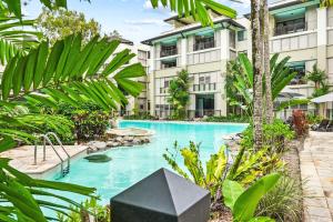 an image of a swimming pool in front of a building at 235 Temple Tranquility Triton Retreat in Palm Cove
