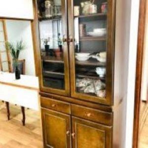 a wooden cabinet with glass doors in a kitchen at Kami House Annex in Osaka