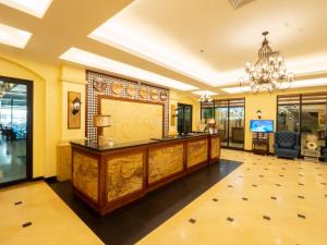 a lobby with a reception desk and a chandelier at Sunlight Guest Hotel, Coron, Palawan in Coron