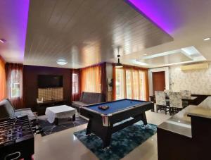 a living room with a pool table in it at Deluxe Pool Villa close to Beach and Walking Street! in Pattaya