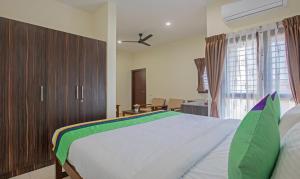 Postel nebo postele na pokoji v ubytování Treebo Samanvaya Retreat, Mysore