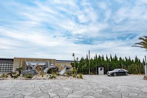 a car parked in a parking lot next to a building at XYZ speciale in Shirahama