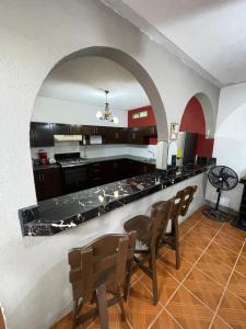 a kitchen with a table and chairs in a room at Casa genesis in Panajachel