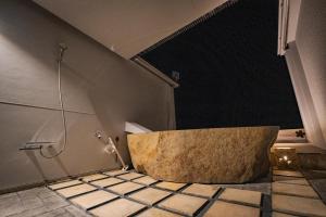 a bathroom with a bath tub in a room at XYZ speciale in Shirahama