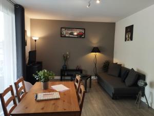 a living room with a table and a couch at La Bellière in Saint-Florent-le-Vieil