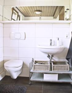 a bathroom with a sink and a toilet at Ferienwohnung Kaim in Prichsenstadt