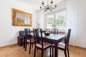 - une salle à manger avec une table, des chaises et un miroir dans l'établissement Private House, à Hanovre