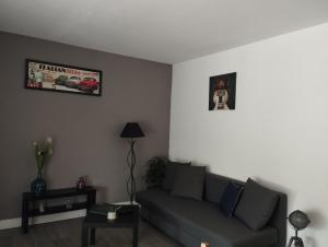 a living room with a couch and a picture on the wall at La Bellière in Saint-Florent-le-Vieil
