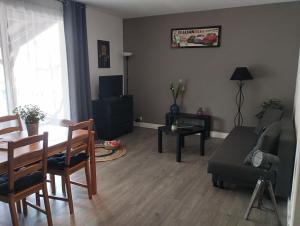 a living room with a couch and a table at La Bellière in Saint-Florent-le-Vieil