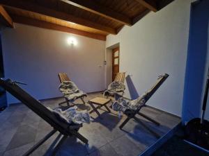 a group of chairs sitting in a room at Paradise Oasis holiday house in Gornji Grad