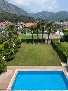 a view of a yard with a swimming pool at blue depth villa in Fethiye