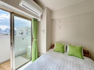 Ένα ή περισσότερα κρεβάτια σε δωμάτιο στο Nishinakajima Apartment