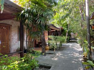 a walkway in front of a house with trees at Samed sand sea resort in Ko Samed