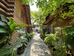 a garden path next to a building with plants at Samed sand sea resort in Ko Samed