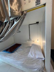 a bunk bed in a room with a mattress at Lay Low AC Hostel Nr Airport Ubon ที่พัก เลโล in Ubon Ratchathani